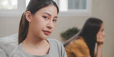 woman quietly distancing herself from friend