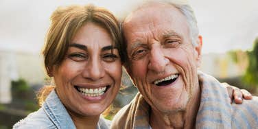 happy woman smiling next to high-quality parent