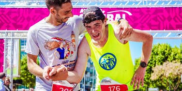 runners helping each other over a finish line
