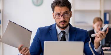 busy man at work looking stressed out