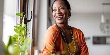 woman smiling while looking out window