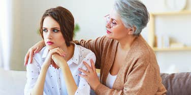woman secretly resenting mother comforting her