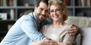 son hugging his mother smiling