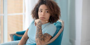 woman questioning if she should cover her tattoos for her boyfriend's family dinner