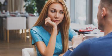 woman expressing her disinterest in man by bad body language