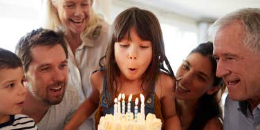 family celebrating little girl's birthday