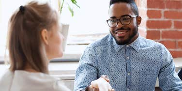 man respecting woman shaking her hand professionally