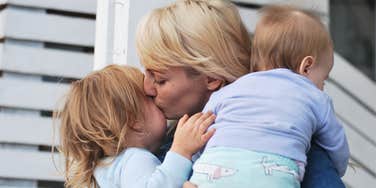 Mom kissing her first born admits to loving first more intensely