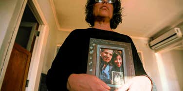 Woman in her home as a adult, with family heirlooms. 