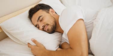 man sleeps on left side of the bed and displays these personality traits