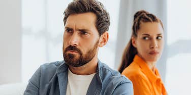 immature husband turning away from annoyed wife