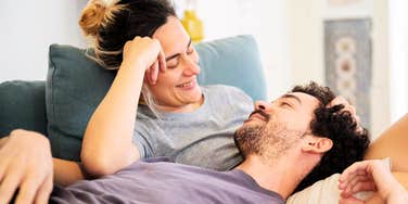 Couple embracing the best relationship advice from dozens of books.