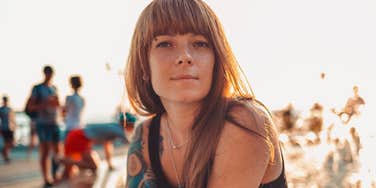 genuine woman smiling by the water