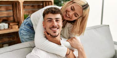 man feeling emotionally safe with girlfriend embracing him