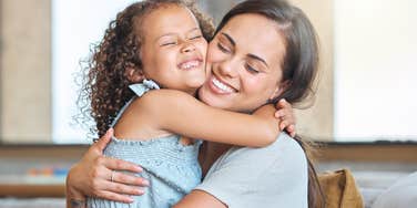mom hugging daughter