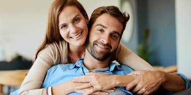 woman lovingly embracing husband from behind