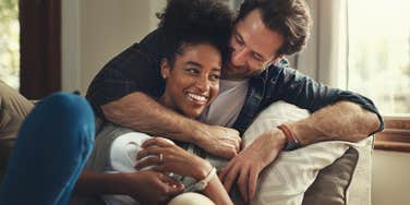 couple cuddling on couch