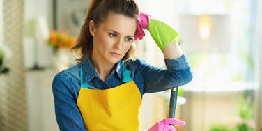 Woman thinking about all the chores she dislikes doing