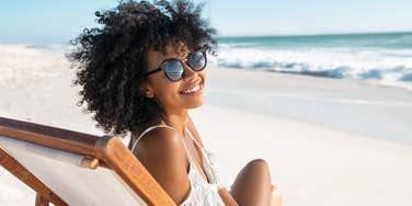 woman sitting on beach enjoying perfect vacation