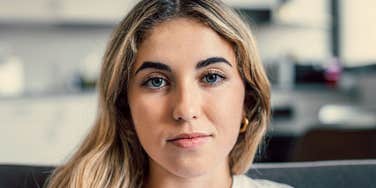 serious millennial woman thinking about how her parents raised her