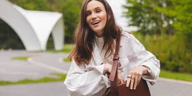 happy woman about to look in her purse