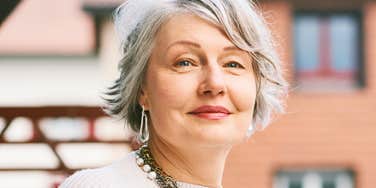 older intelligent woman with a high iq smiling
