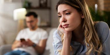 sad woman turned away from partner afraid he will leave her