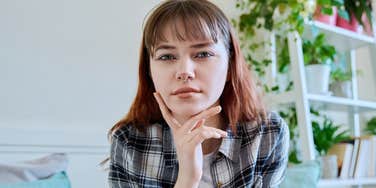 working class young woman thinking about wealthy people habits