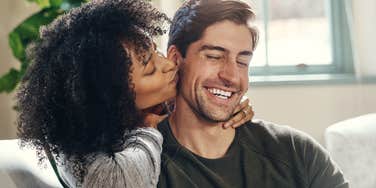 woman kissing mans cheek deeply in love with him