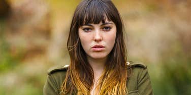woman pretending things are normal looking upset