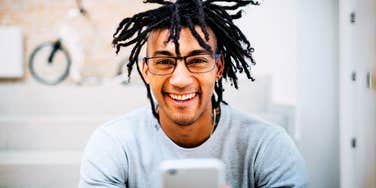 Man getting a text that makes him feel seen and desired. 