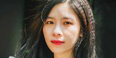 Asian woman child of immigrant parents. 