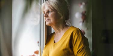 Woman watching neighbor while she cleans because she draws her husband's attention