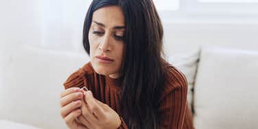 woman unhappy with engagement ring