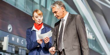 Airline employee helping traveler