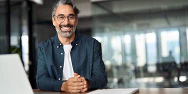 boss smiling sitting in office