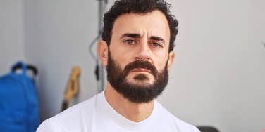 deeply unhappy man having fight with partner on regular basis.