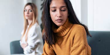 woman turned away from friend who feels entitled to her time and energy