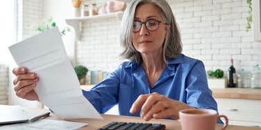 Grandma calculating invoice to send to daughter for granddaughter's visit
