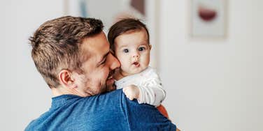 dad holding newborn baby