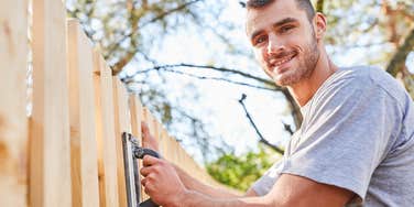 man building fence