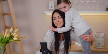 mom recording video with daughter