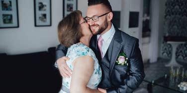 mother of the groom hugging her son