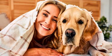Person sharing a bed with their pet. 