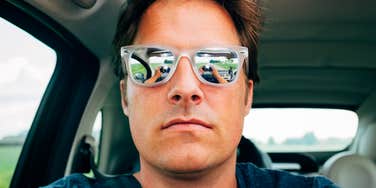 Cheating man taking a selfie while in his car. 