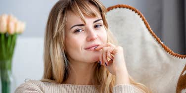 extremely smart woman thinking on a couch