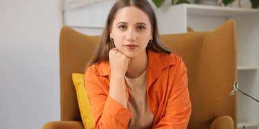 frugal woman sitting alone in her living room