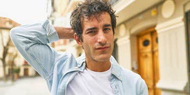 man looking embarrassed putting hand on his head