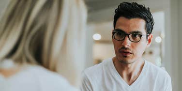 hardworking man talking to lazy person