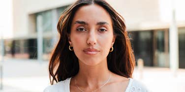 serious looking woman seeming low class